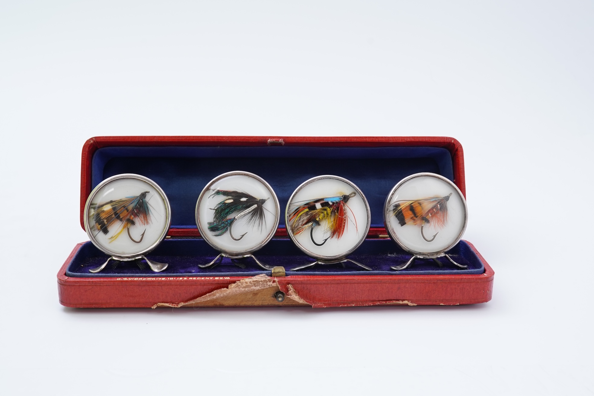 A set of four early 20th century silver mounted fishing related novelty menu holders, by Grey & Co, housed in a red leather case with gilt initials RV